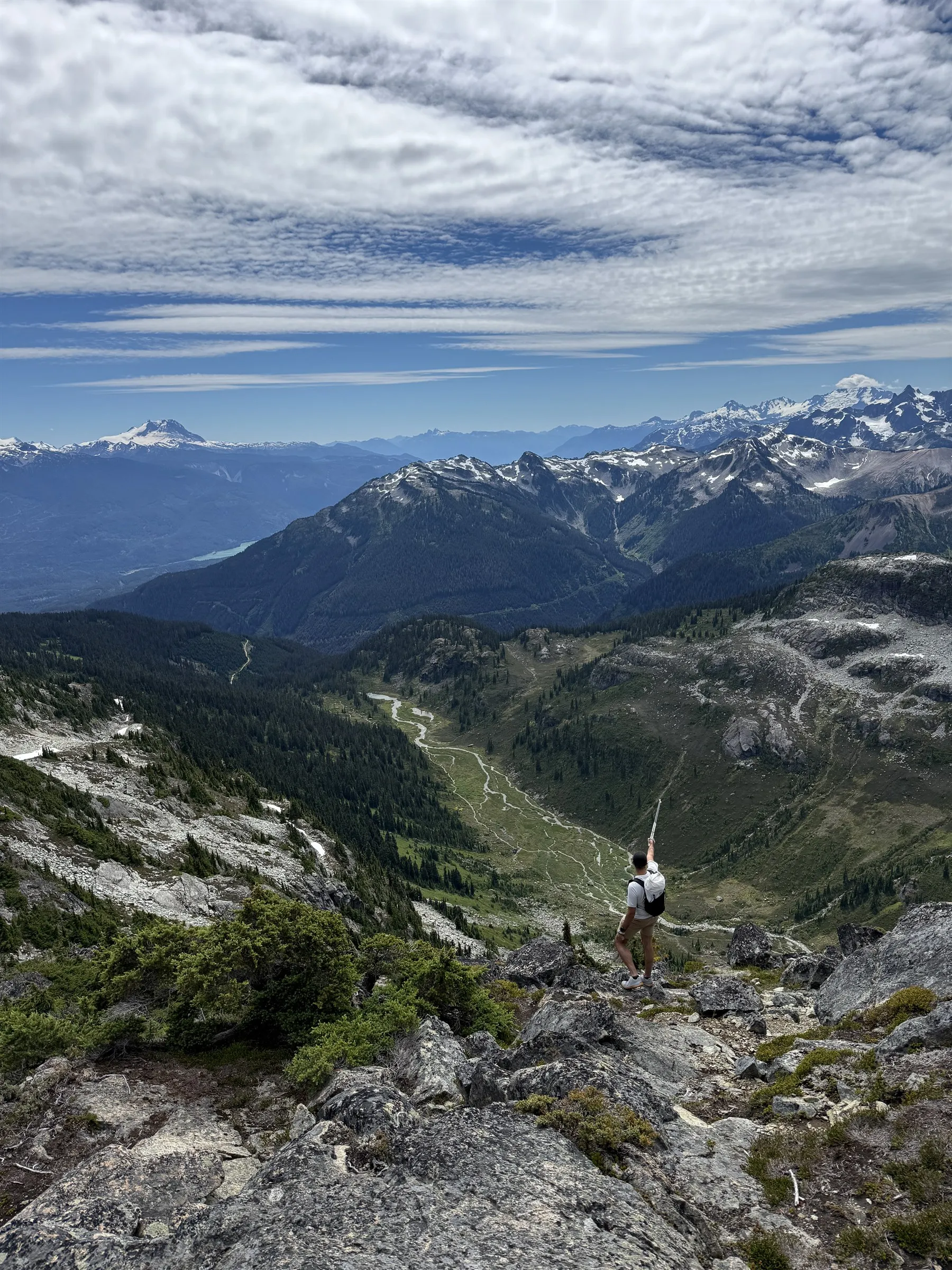 Jordan standing above Brandywine Meadows and pointing across the broad descent basin