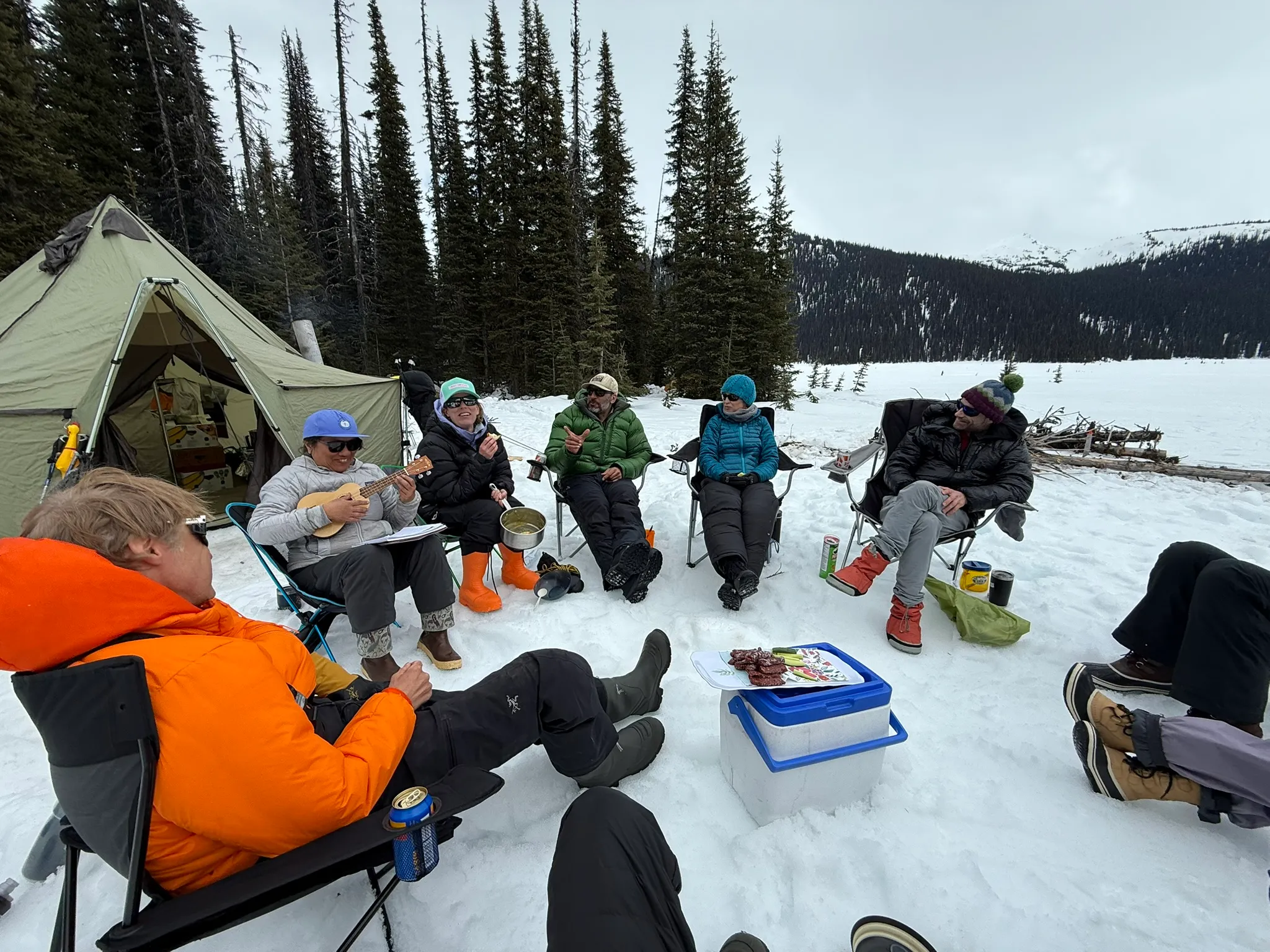 The ski group eating lunch together in camp beside the cook tent