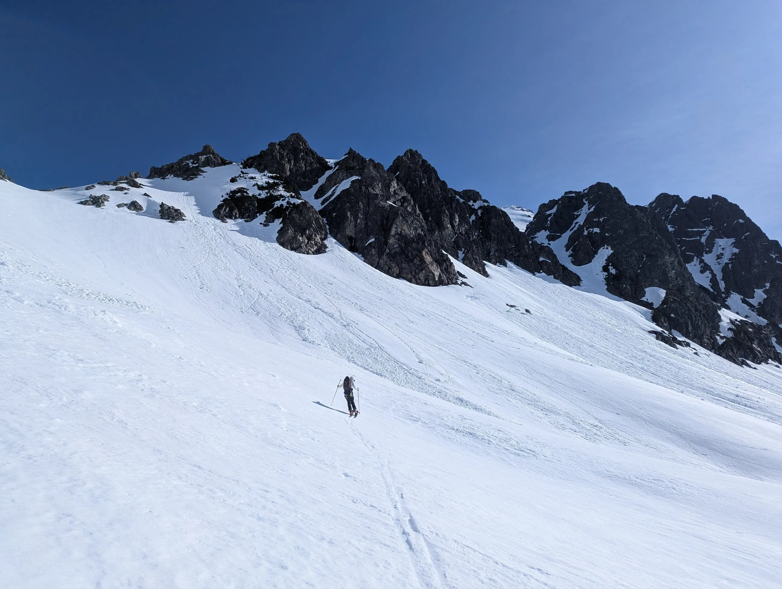 Jordan crossing low-angle snow after leaving the avalanche terrain below Serratus
