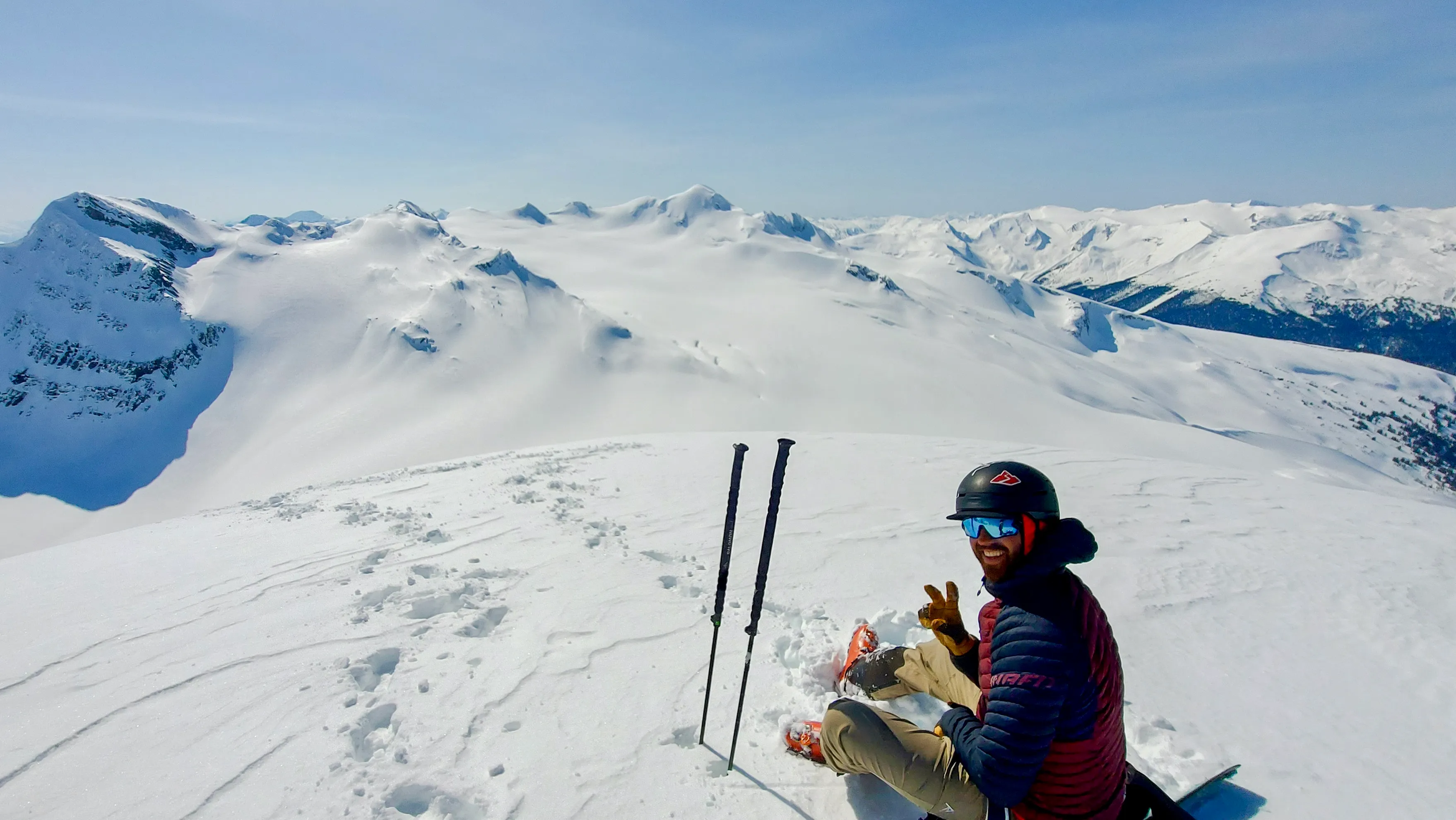 Chris eating and waiting on the summit of Lil' Baby above the surrounding Cariboo terrain