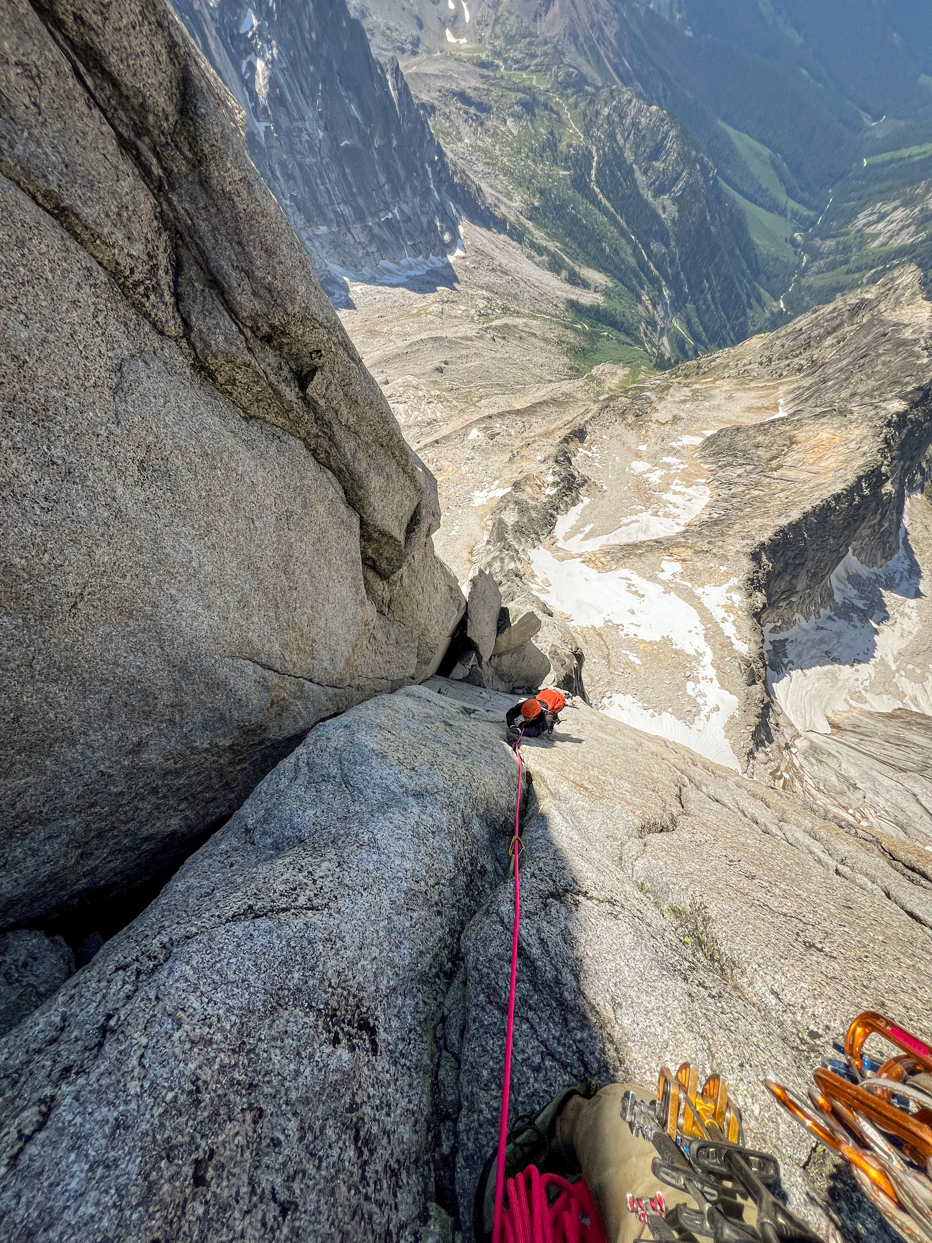 Chris climbing a steep granite corner high above East Creek