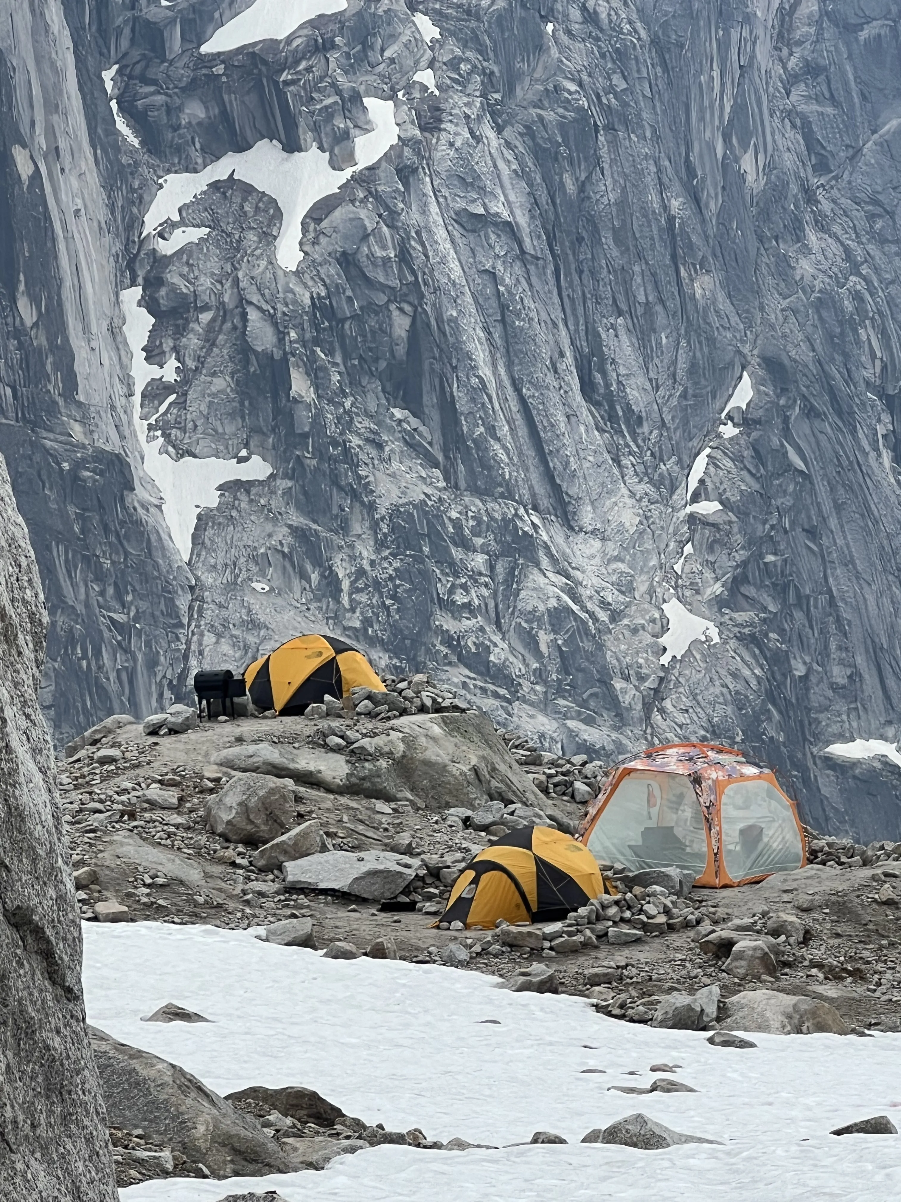 Tents and a Traeger grill beneath the granite walls at East Creek camp