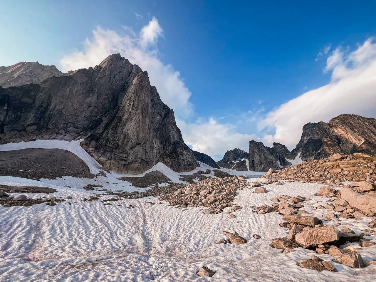 Granite spires above snow and talus on the approach to East Creek